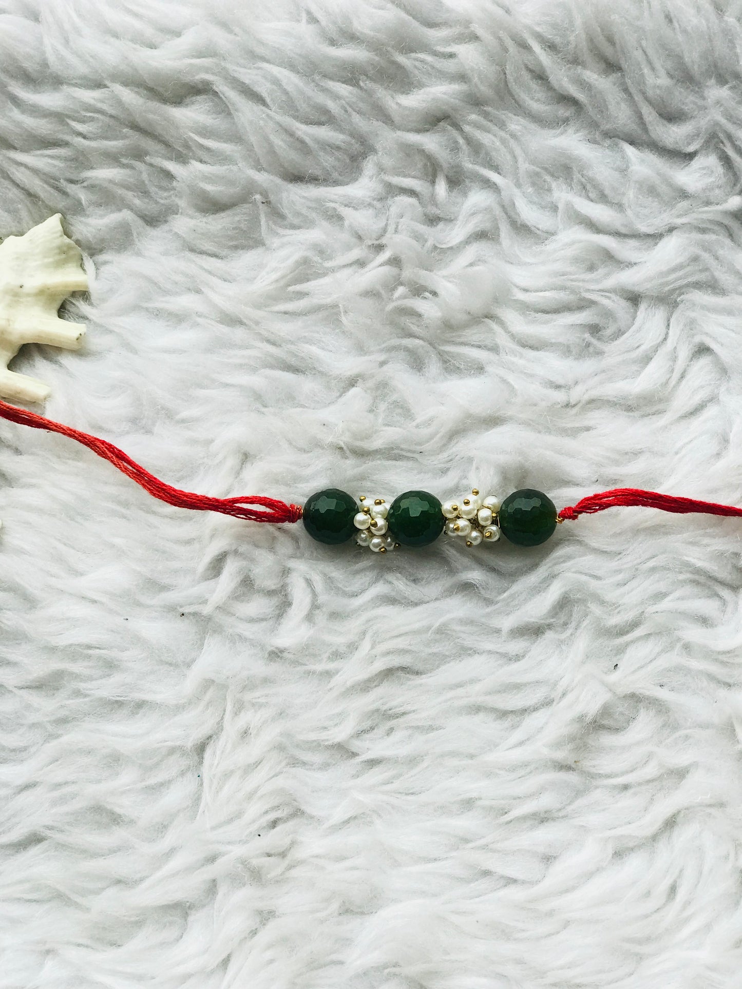 Green onyx stone with pearl mauli rakhi