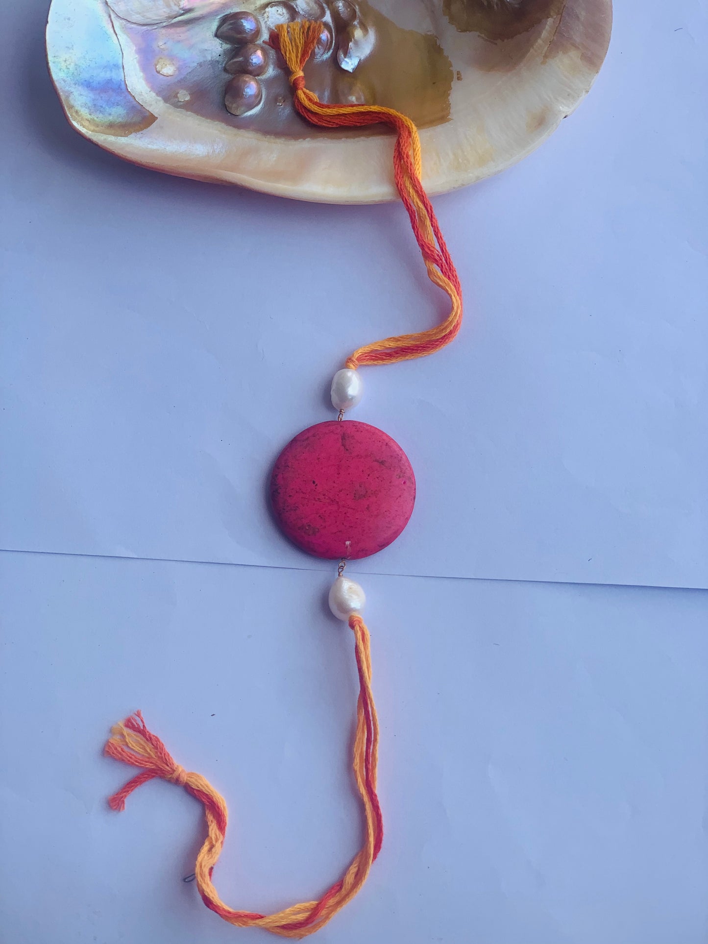 Pink coral with pearl rakhi in mauli