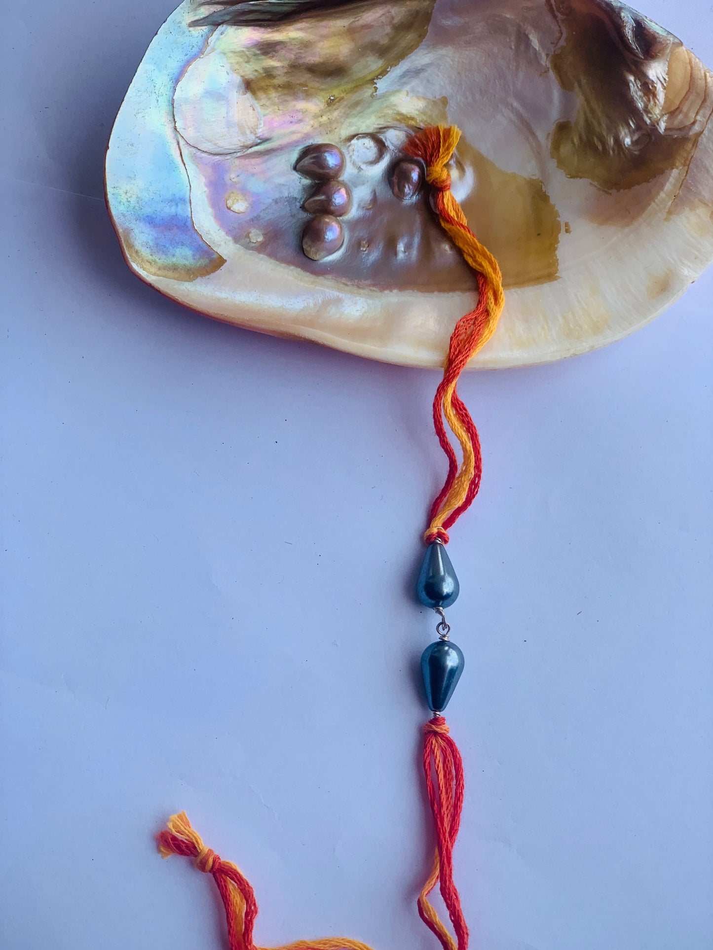 Grey pearl in mauli thread