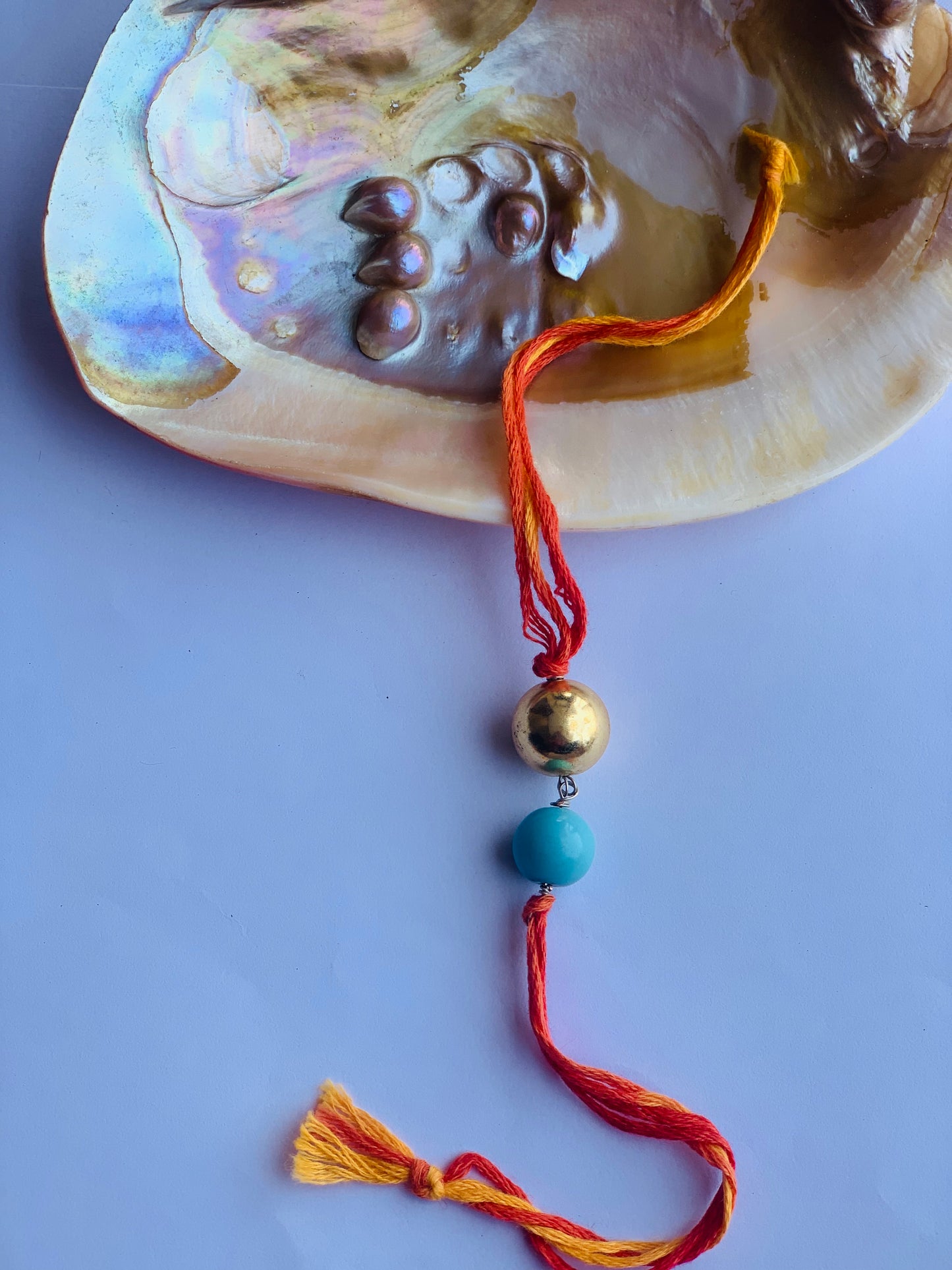 tourquise stone & golden ball in mauli thread