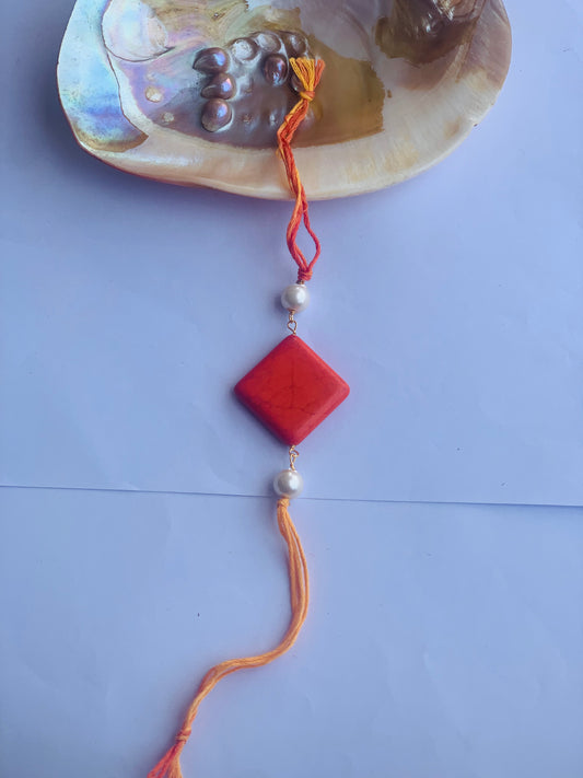 Orange coral with pearl mauli rakhi
